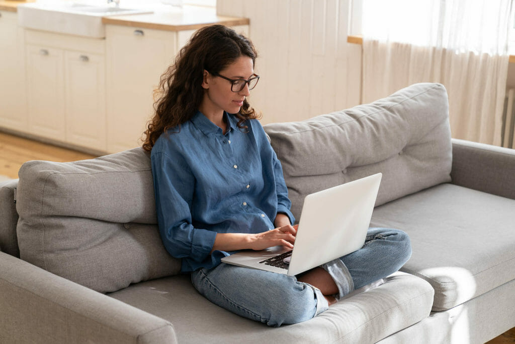 woman on laptop completing certification exam