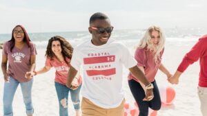 Coastal Alabama College students laughing on the beach